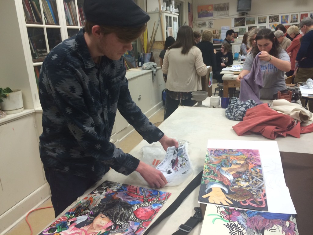 Elijah showing Guild members some of his artwork. 